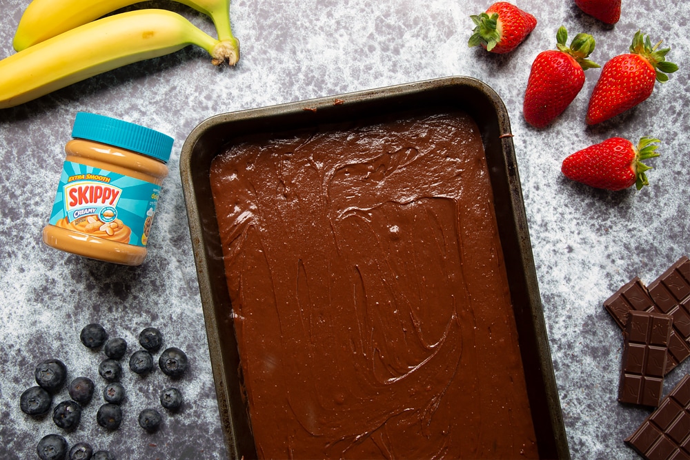 The mixture inside a baking tin ready to be baked into the peanut butter brownies