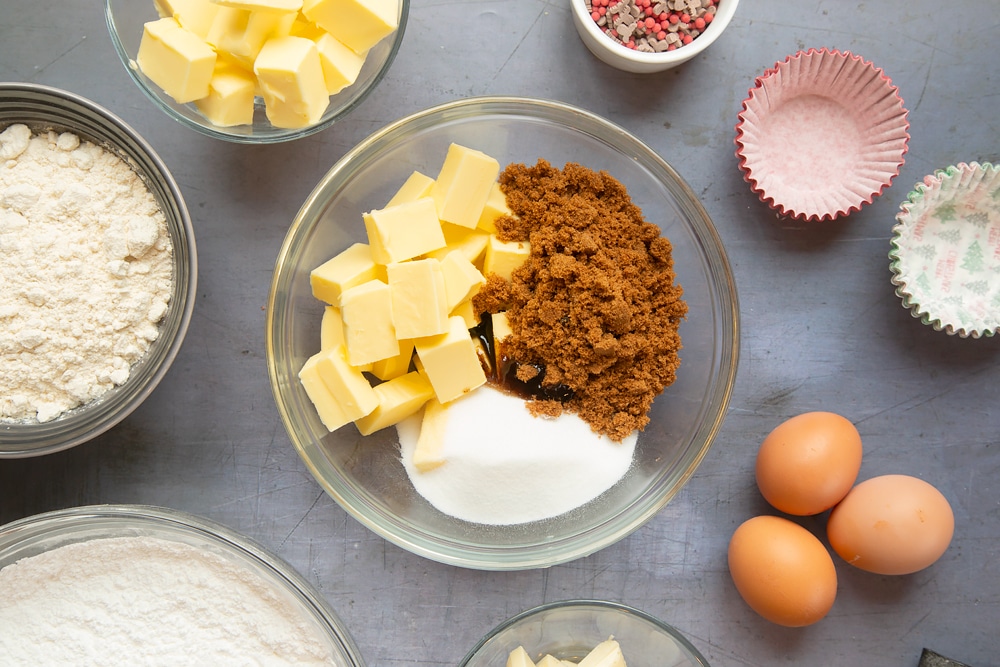 Overhead shot of a pyrex bowl with some of the ingredients required to make the spiced Christmas cupcakes with marzipan frosting.