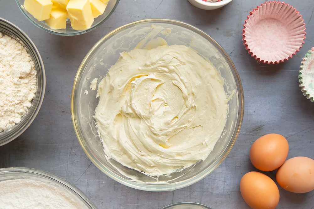 Mixing together the ingredients for the marzipan frosting in a bowl.