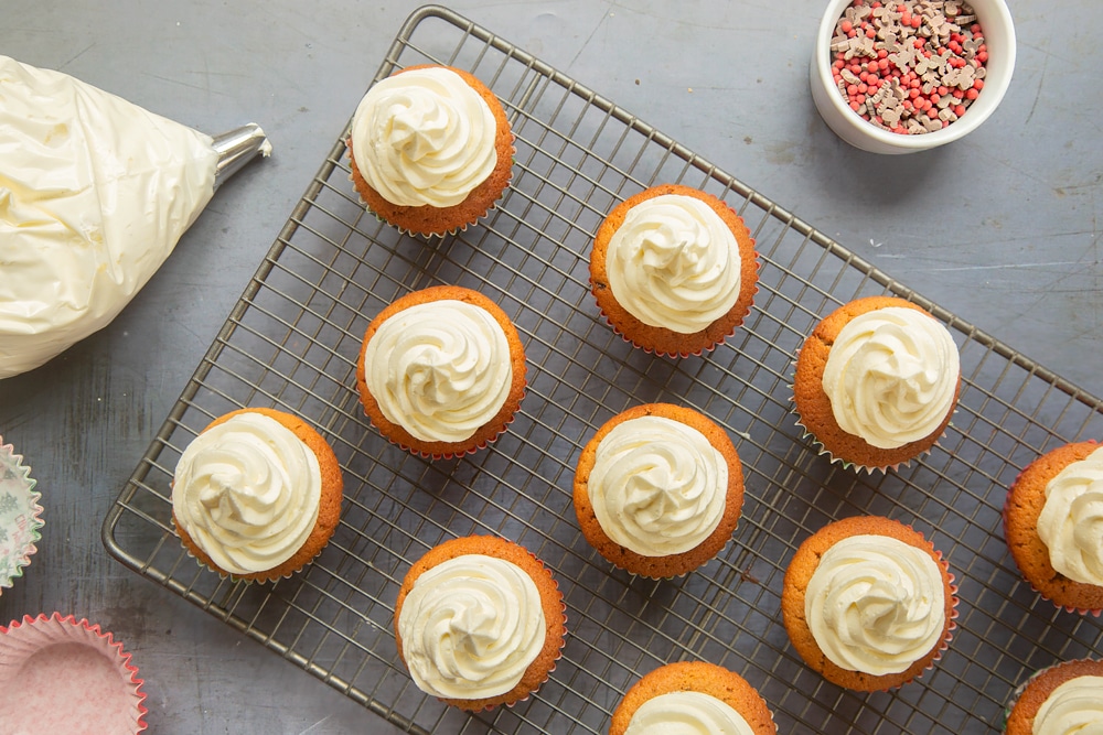 Overhead shot of piping the marzipan frosting onto the cupcakes.