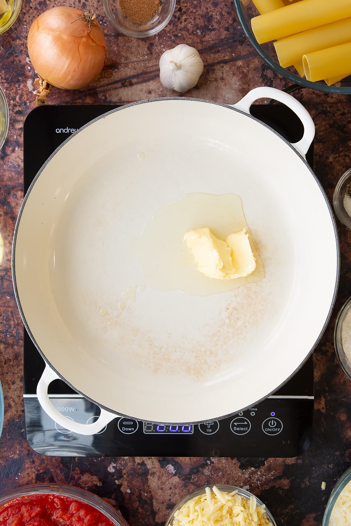 Overhead shot of oil and butter being melted in a pan.