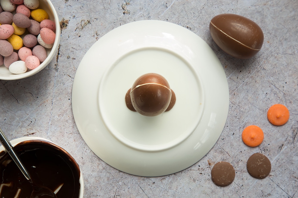 Overhead shot of upside down plate with an upright chocolate egg