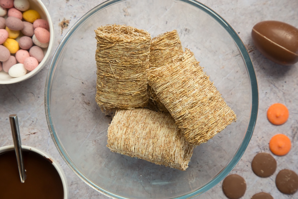 Crush the wheat in a bowl for the first step in this Easter chick and nest activity