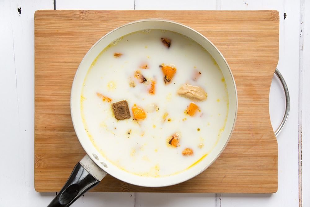 roasted butternut squash soup ingredients poured into a large saucepan with the stock cube, milk, peanut butter and boiling water