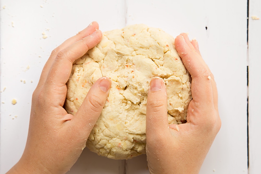 Chilli cheese savoury scones dough in hands