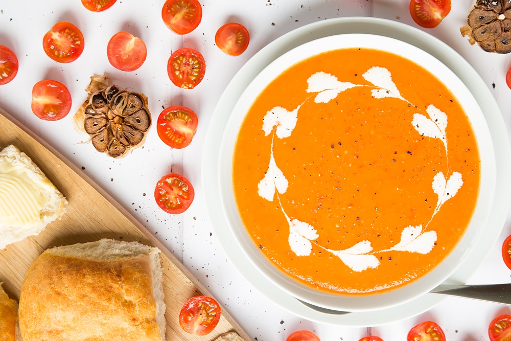 Serve your roasted tomato and garlic soup with creme fraiche and crusty bread