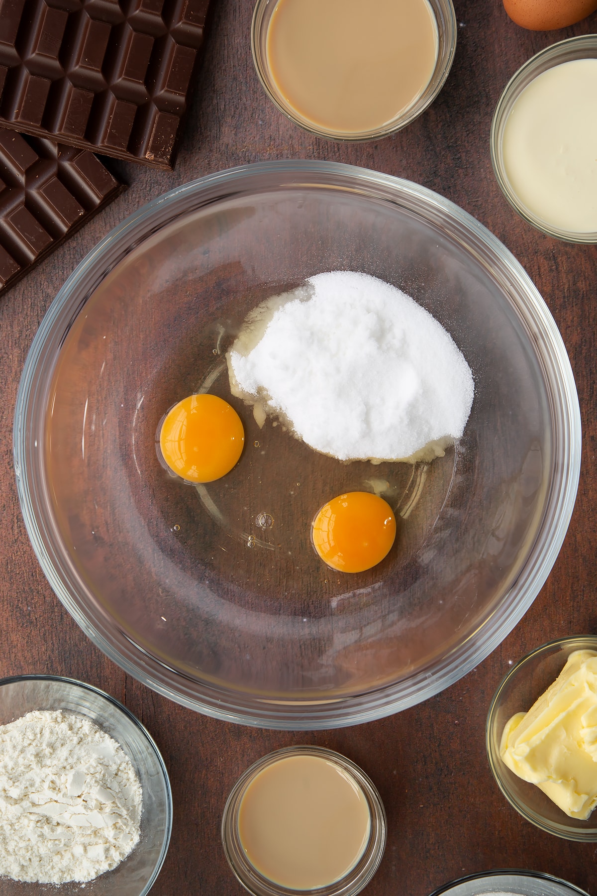 2 eggs and sugar in a clear bowl.