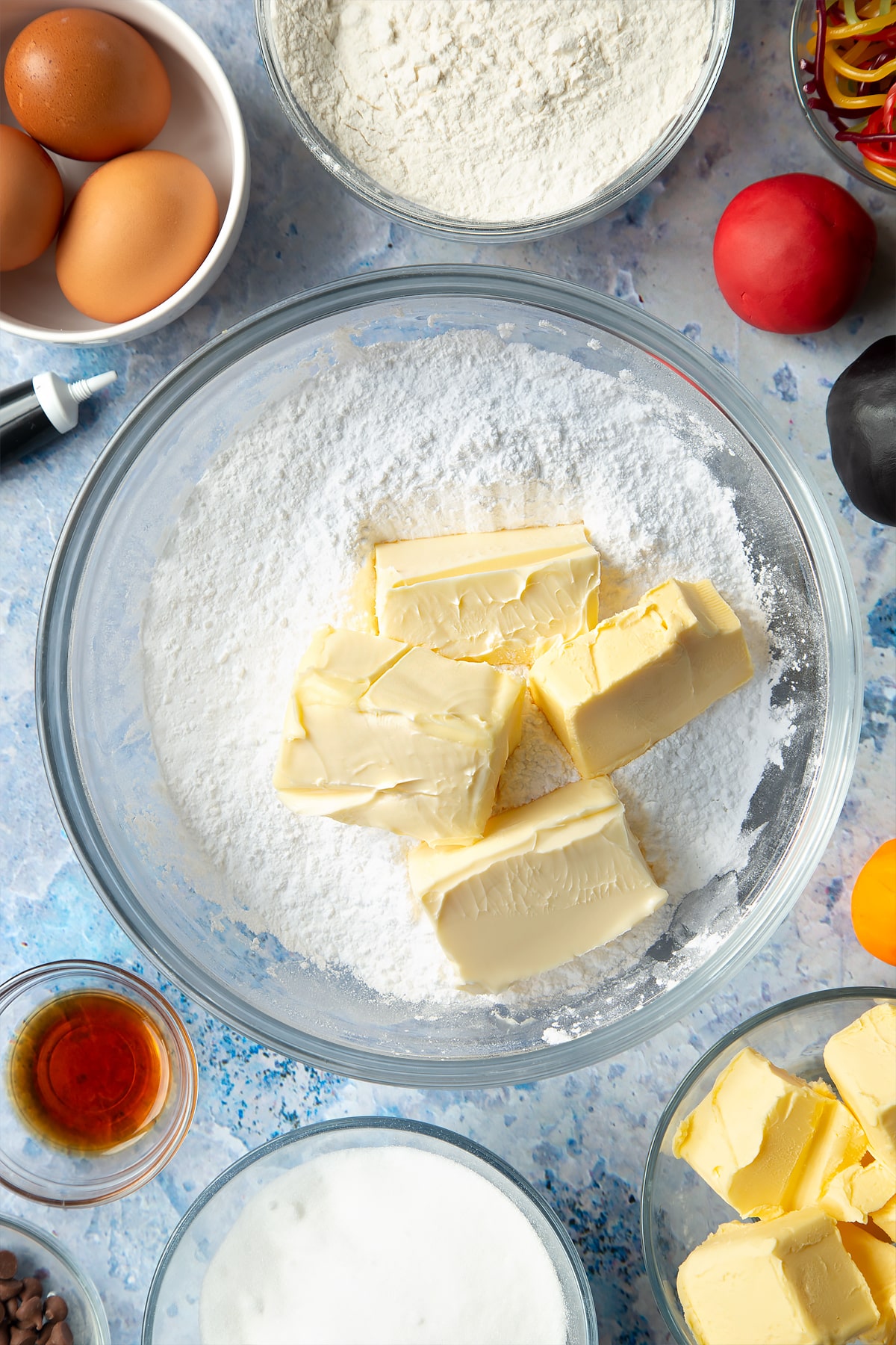 Mixing together butter and flour to make the frosting for the snowman cupcakes.