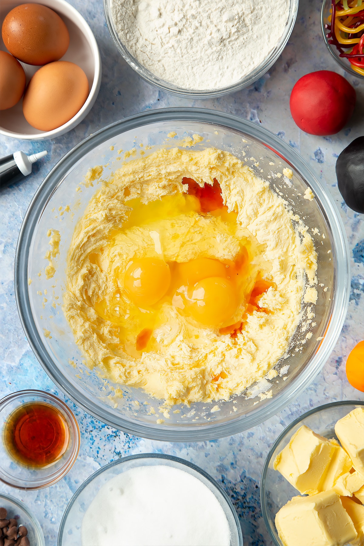 Adding eggs to the snowman cupcakes mixture.
