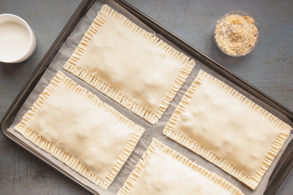 Mark the edges with a knife and transfer to a baking tray