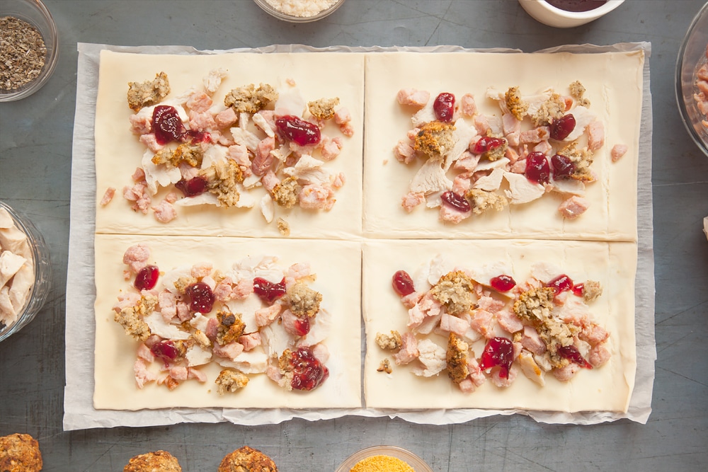Dotting the pastry sheets with cramberry sauce.