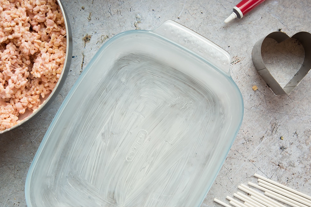 A greased tray, ready to pour the heart crispy cake pops mix into