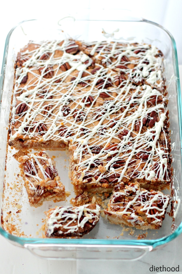 Caramel Pecan Pie in a clear glass pyrex dish covered with icing and bites missing from the dish.