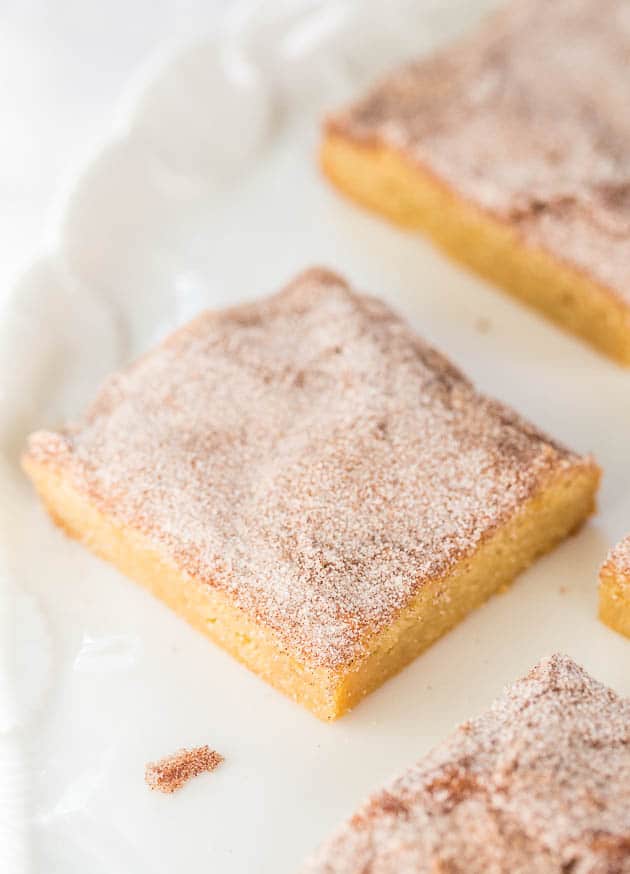 a square piece of Snickerdoodle Bar on a white plate