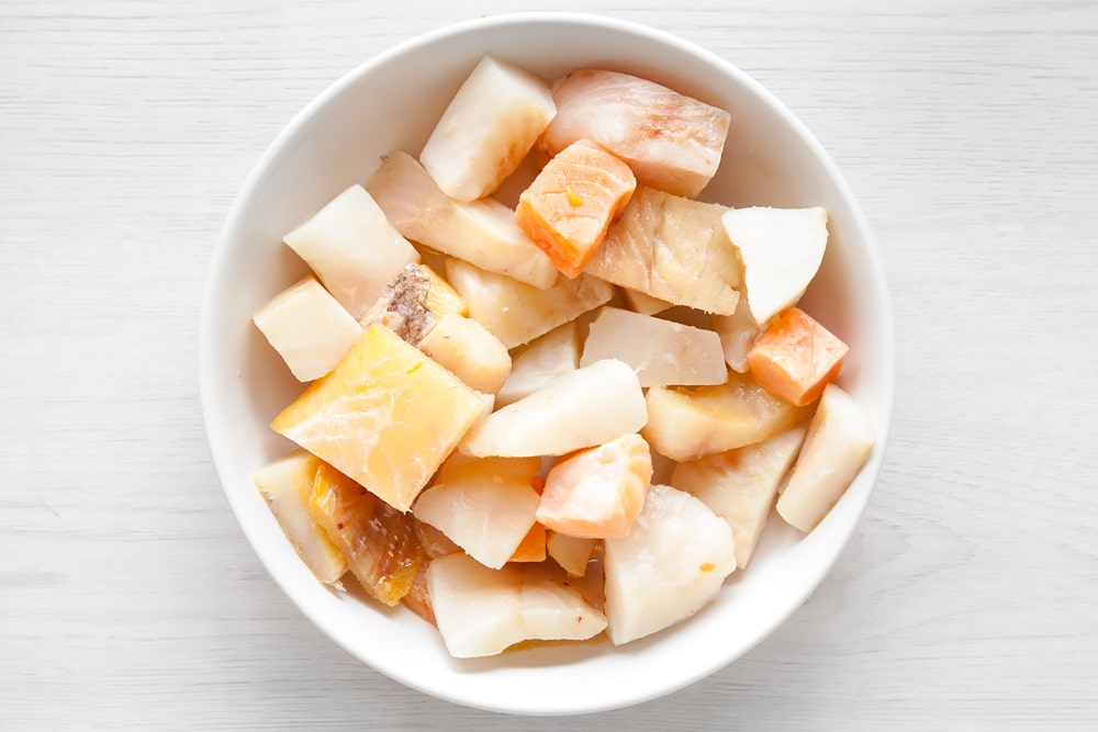 Frozen fish pie mix in a bowl