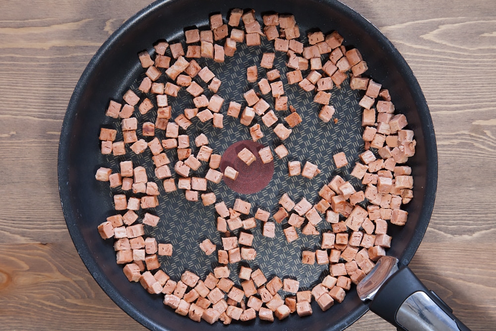 cooked Quorn meat free bacon lardons in a frying pan