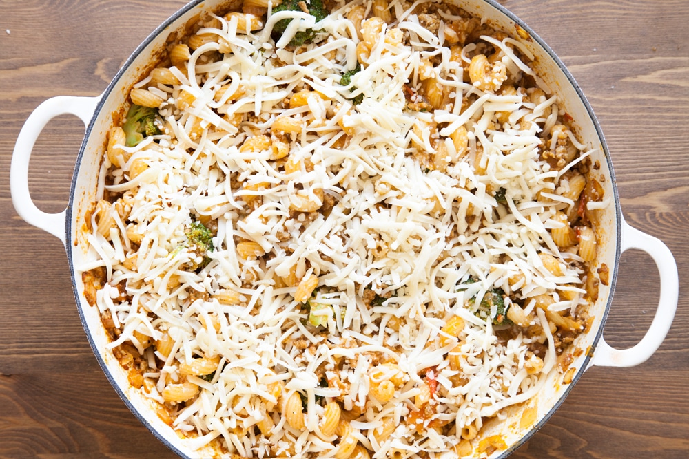 Sprinkle the chunky keema pasta bake with cheese before baking