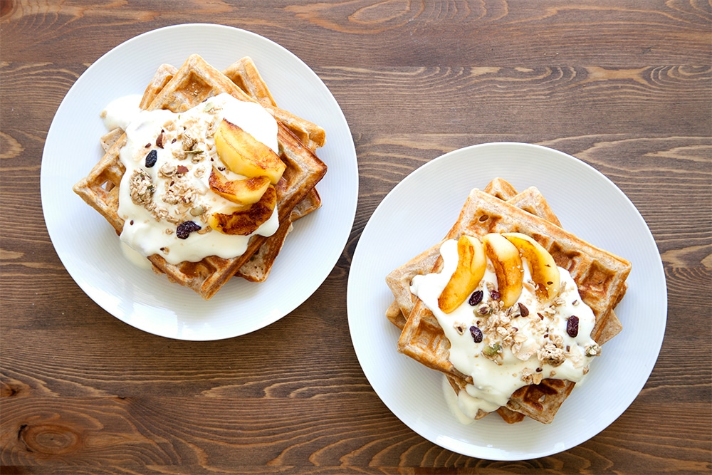 Garnished granola waffles with coconut fried apples