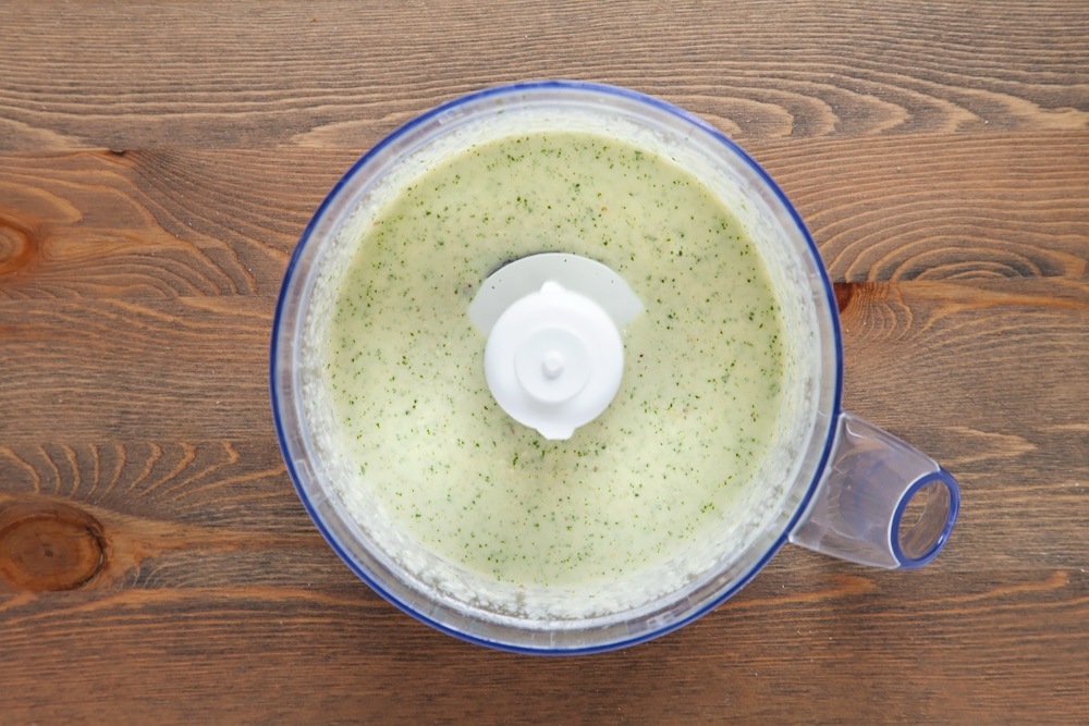 Blitzing ingredients for the pesto in a food processor