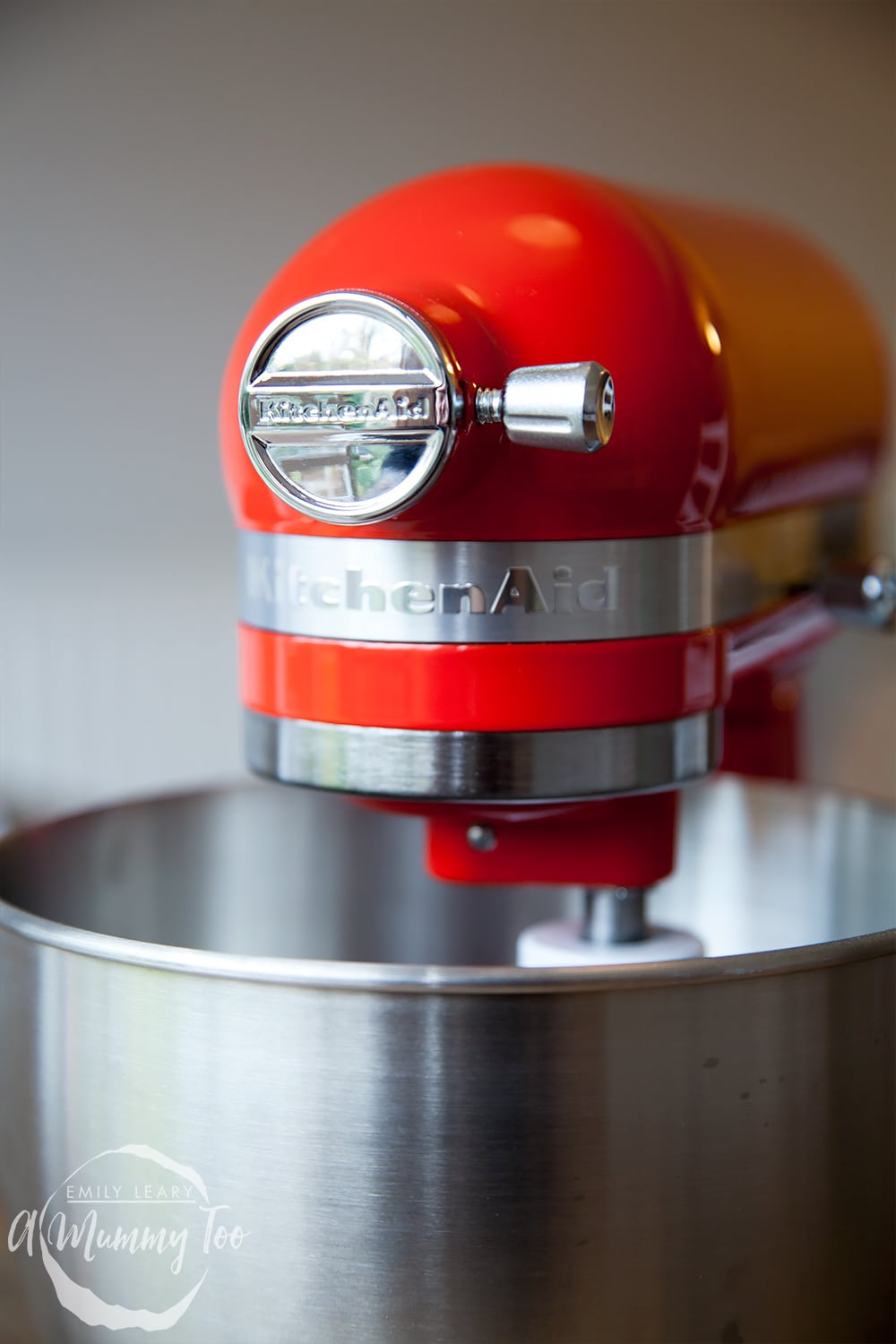 Face on view of the red KitchenAid mini with the bowl attached.