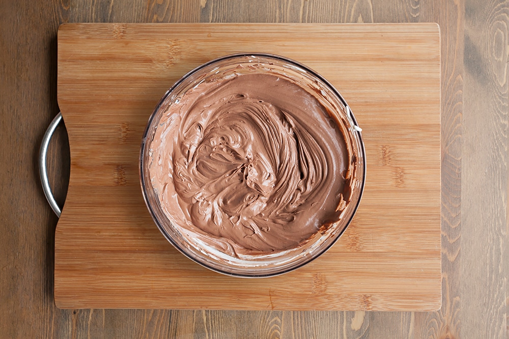 Whipped cream mixed with chocolate fudge icing, ready to assemble the pancake stack!