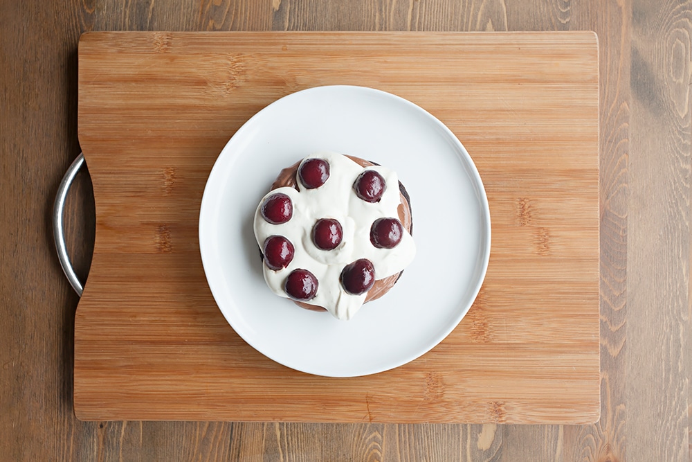 Add a layer of pitted, halved cherries to the black forest pancake stack