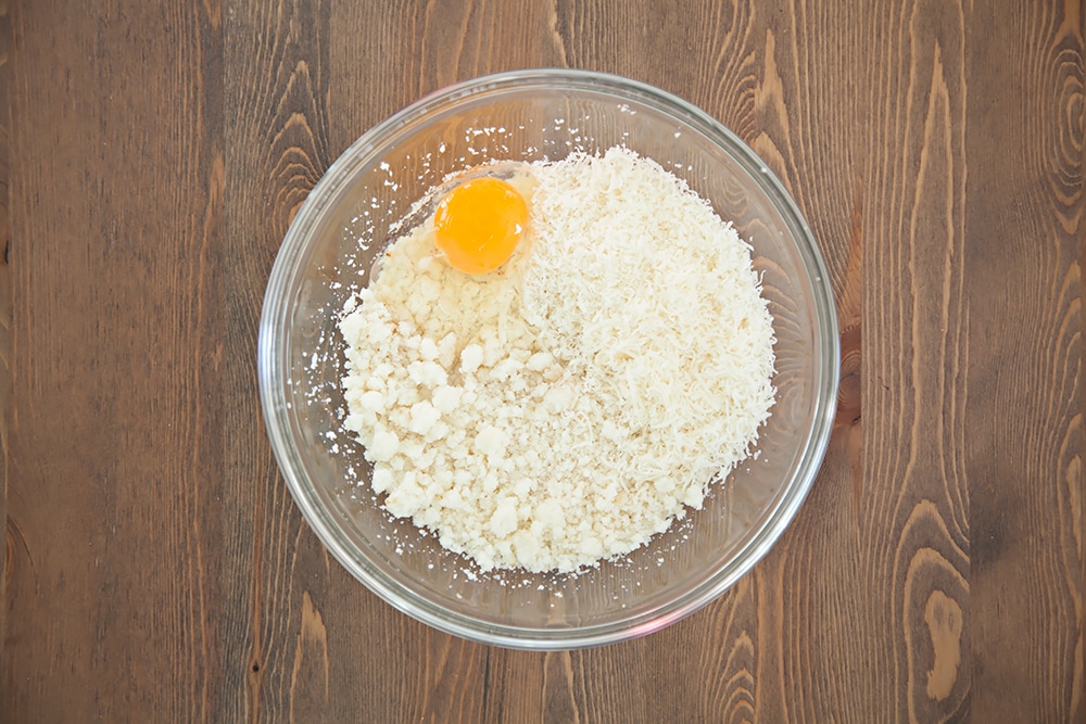 Adding egg to the cauliflower crust mix