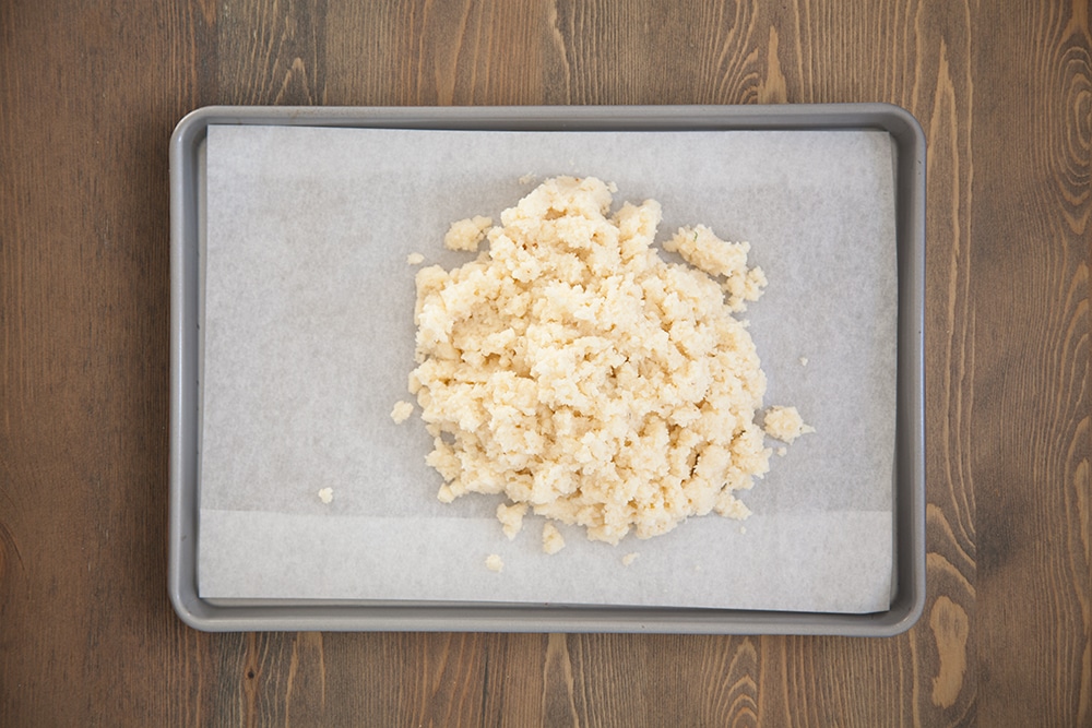 Preparing the cauliflower crust base for baking