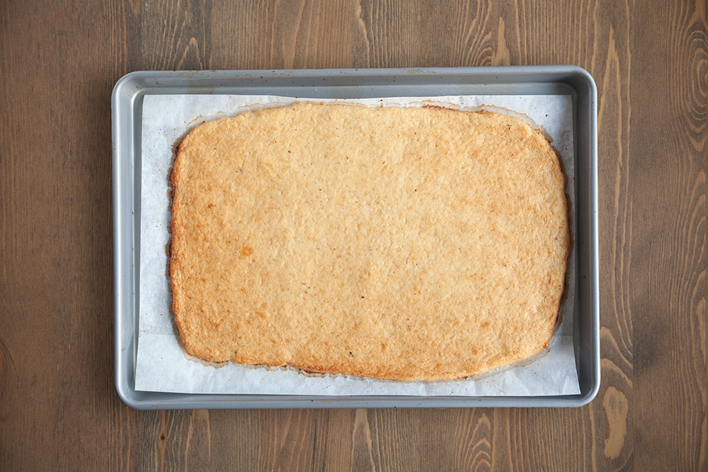 Baking the crust for this tasty Grana Padano and Prosciutto di San Daniele cauliflower crust pizza