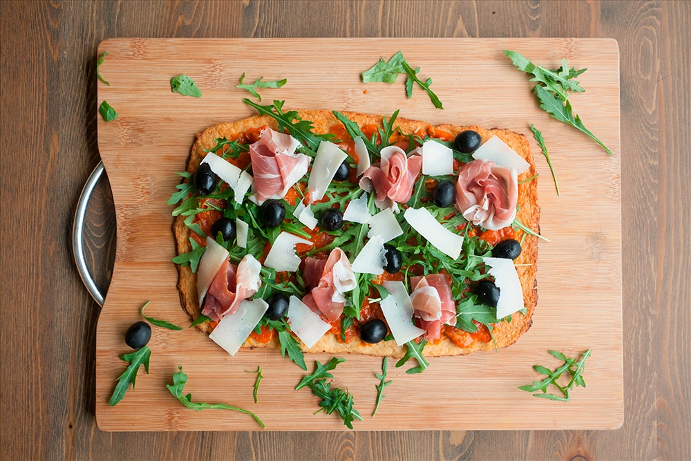 Shaved Grana Padano tops the Grana Padano and Prosciutto di San Daniele cauliflower crust pizza
