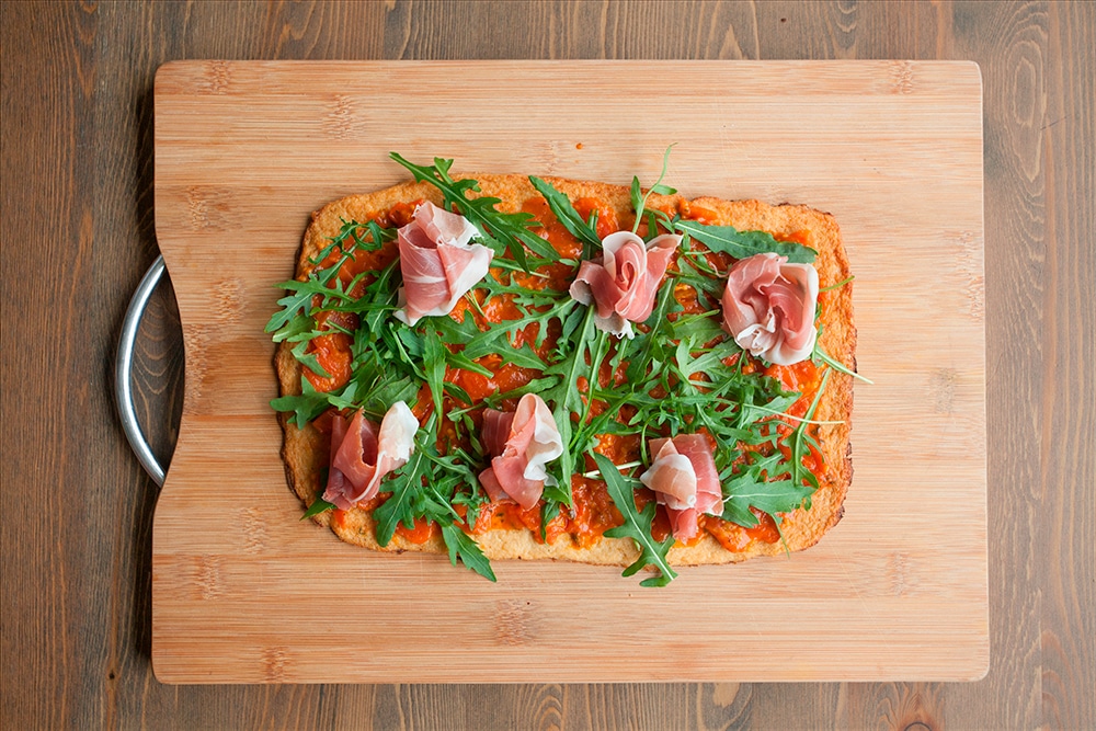 Prosciutto is added to the cauliflower crust pizza
