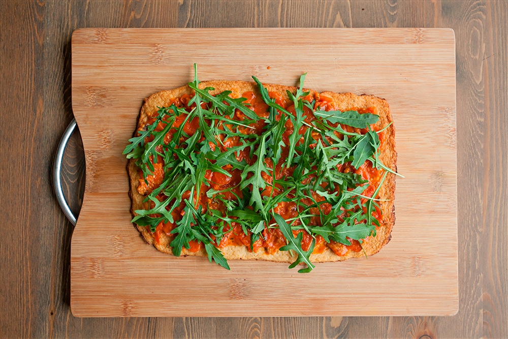 The Grana Padano and Prosciutto di San Daniele cauliflower crust pizza is sprinkled with rocket