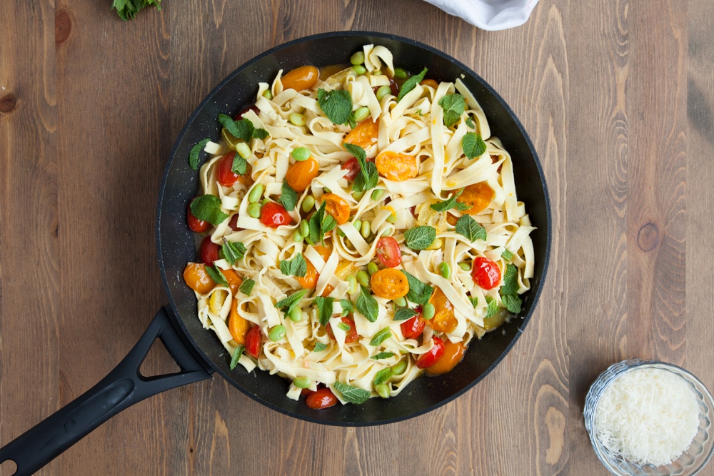 Top the tagliatelle with tricolour tomatoes and edamame with fresh mint