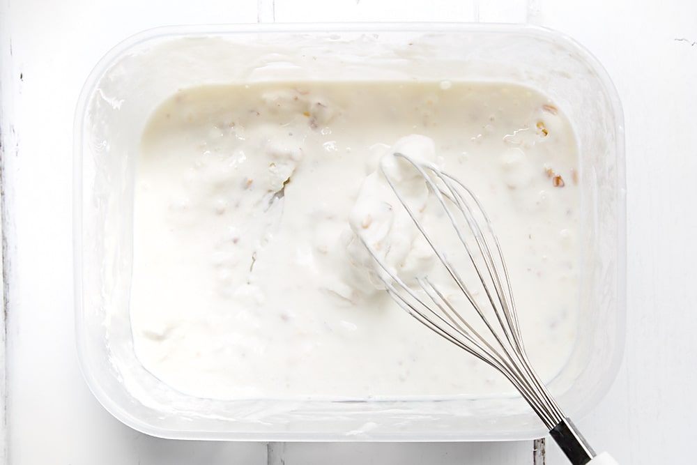 Preparing the breakfast froyo by whisking the frozen yogurt