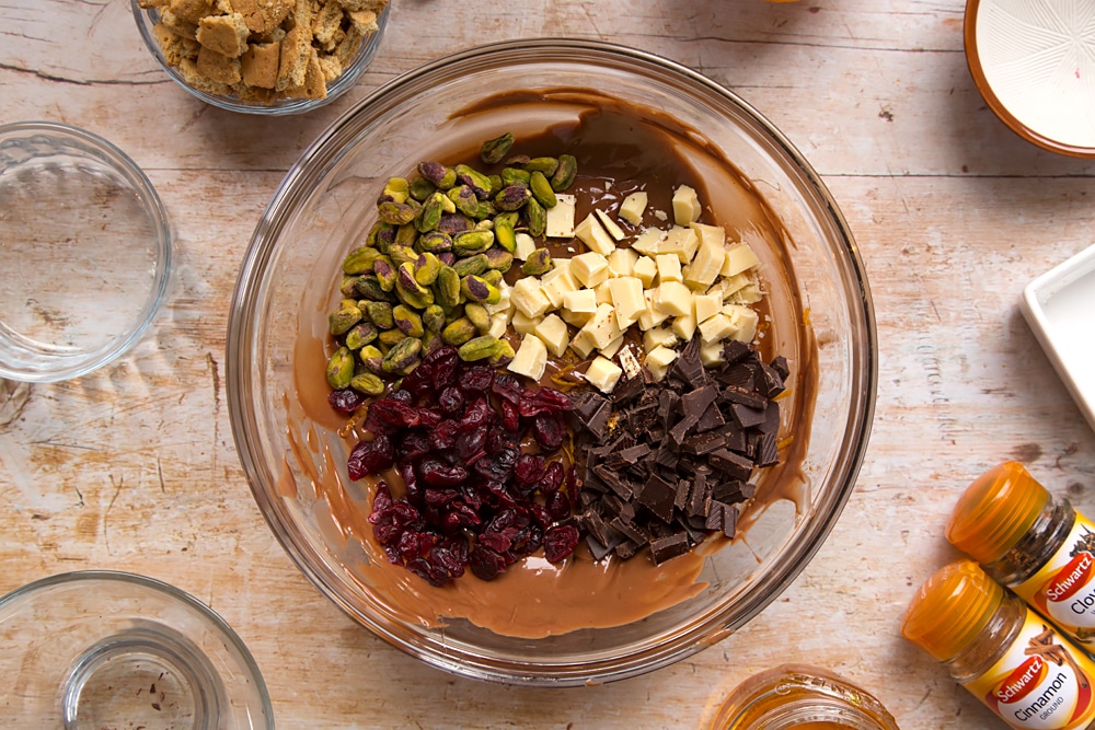 Step by step instructions to make Christmas spiced chocolate salami: chocolate, pistachios and cranberries are added