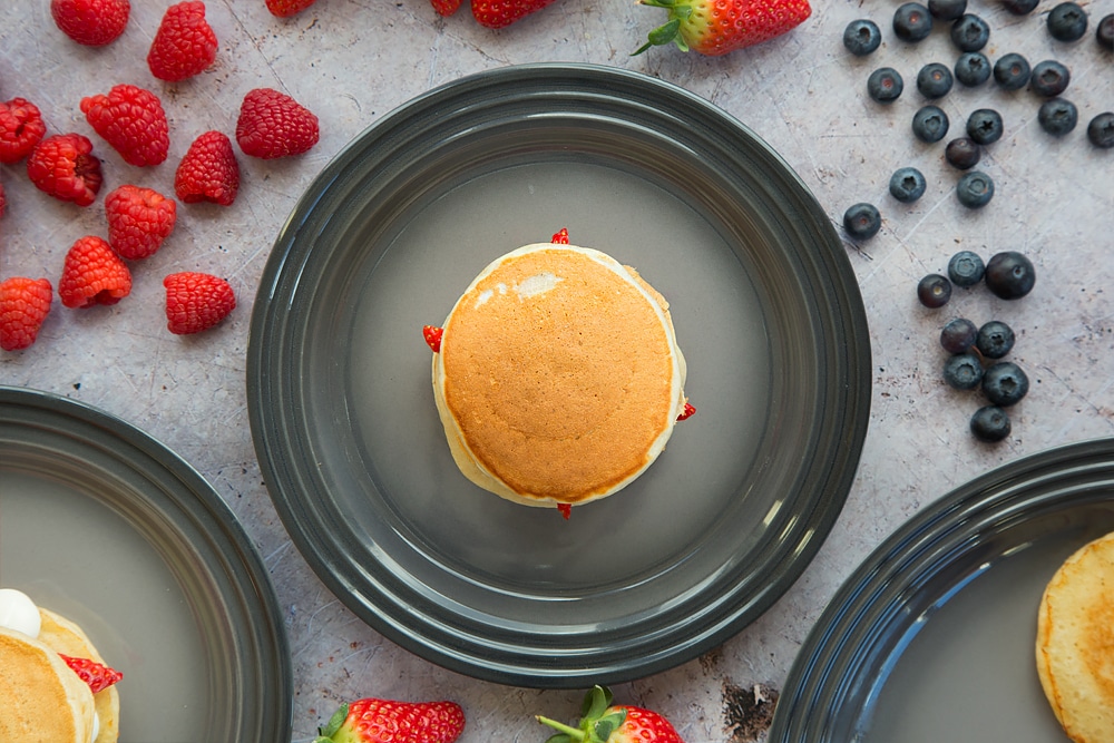 A final pancake is added to the top to create a fruity pancake stack