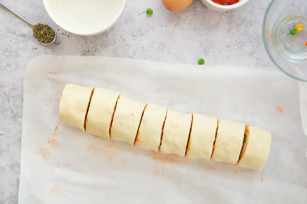 Cutting the pizza pastry roll up into eight pieces