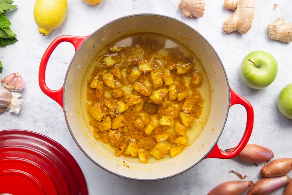 Adding a stock cube to the curry sauce mix