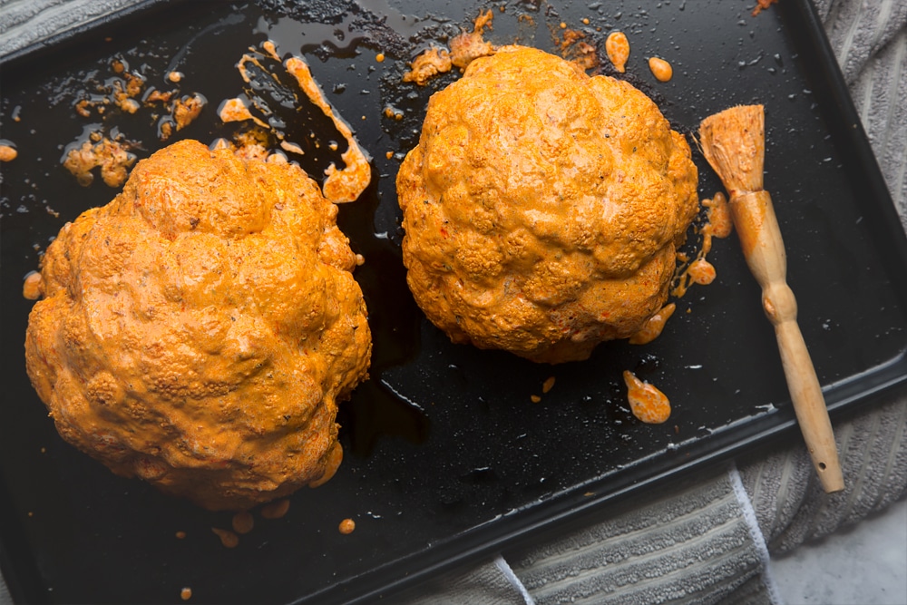 Add any extra harissa yoghurt to the harissa roasted cauliflowers