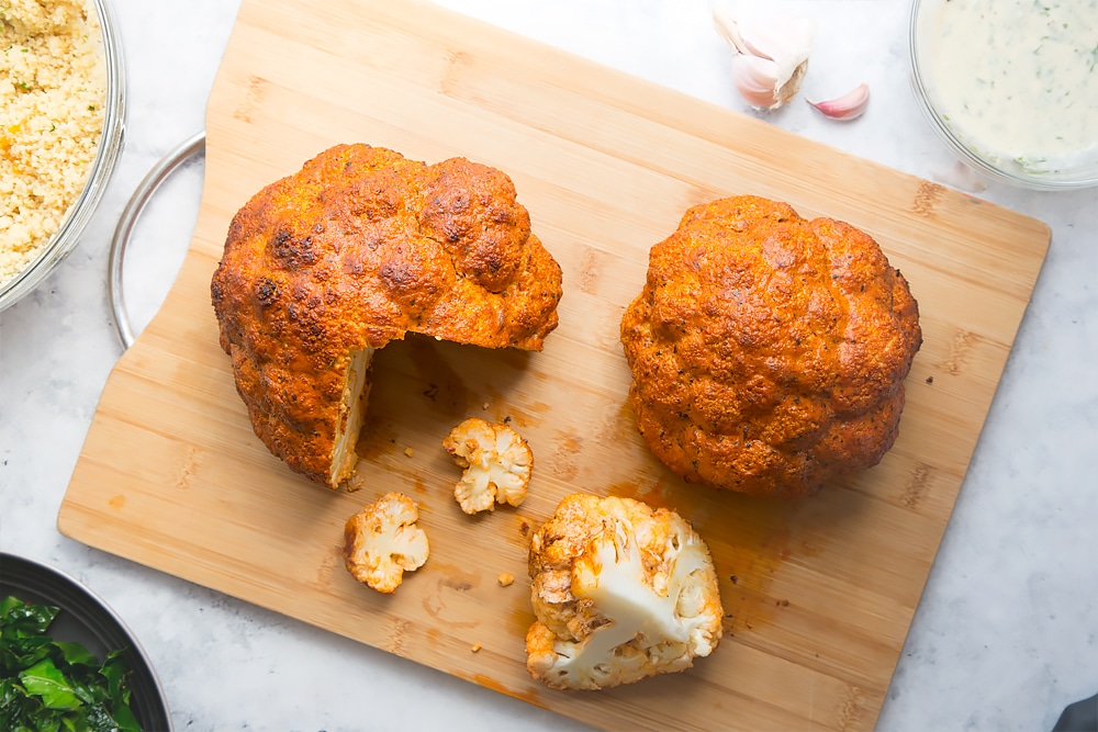 Cooling harissa roasted cauliflowers before being cut into sections