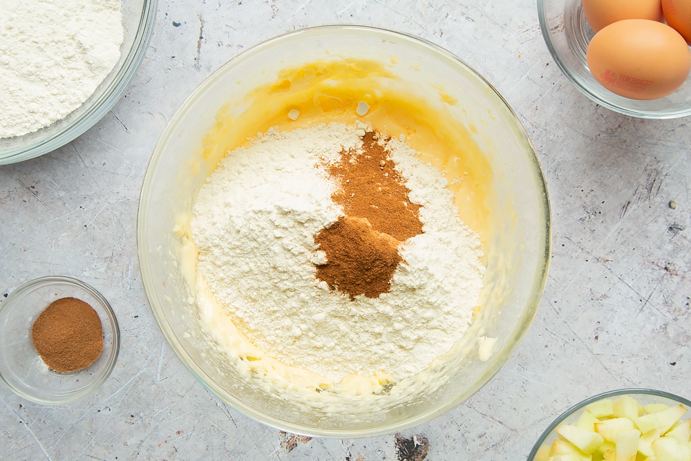 Flour and cinnamon are added to the cake mix