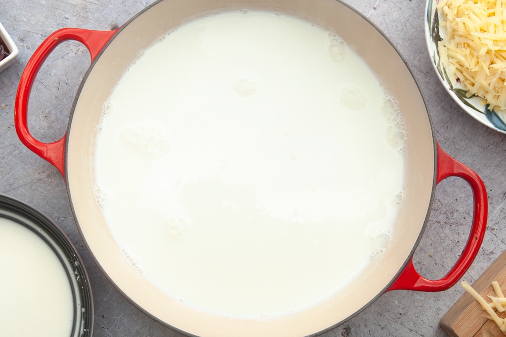 Milk poured into a pan, ready to make the harissa mac and cheese sauce