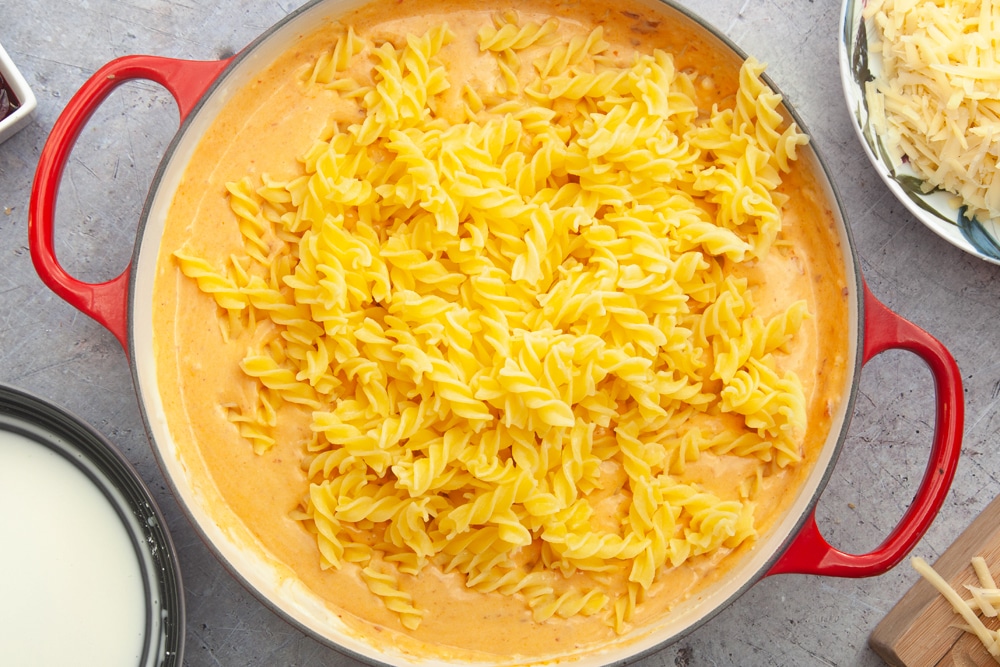 Adding partially cooked pasta to the cheese sauce