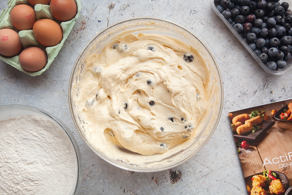 Adding blueberries to the cake mixture