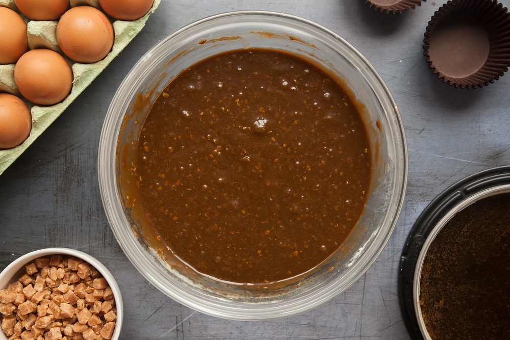 Overhead shot of muffin mixture in a large clear bowl