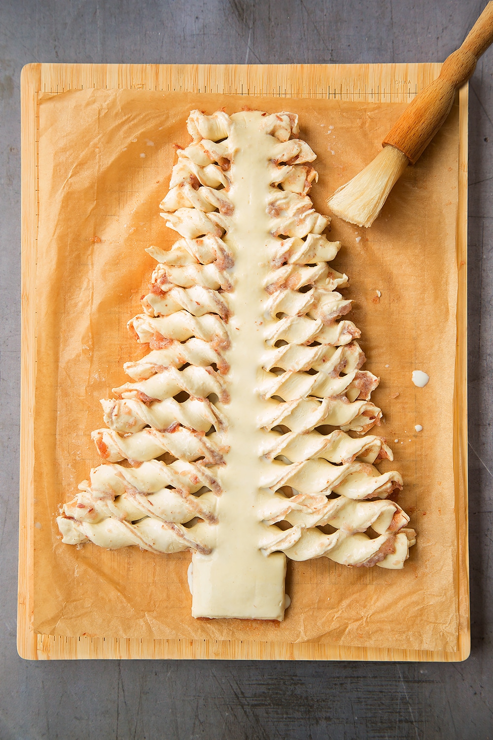 Brush your puff pastry Christmas tree with milk
