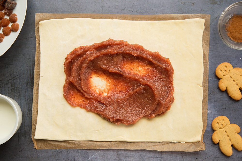 Spread cooled applesauce on the puff pastry sheet