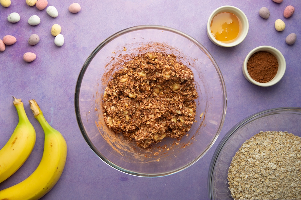 Mashed banana, cocoa and oats mixed together in a bowl