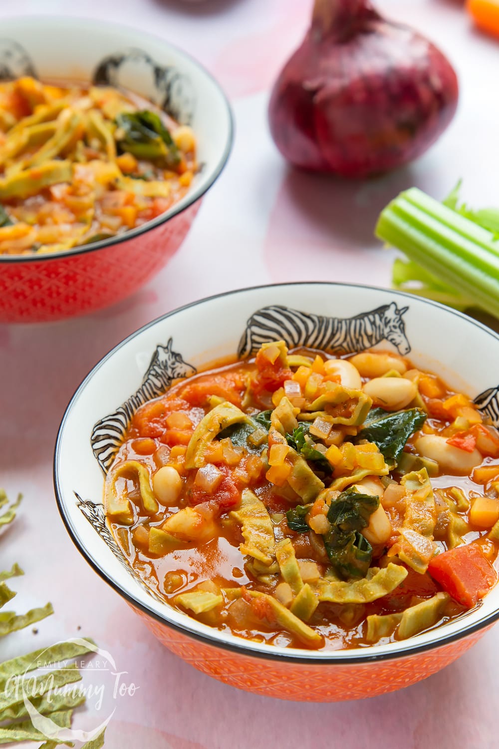 A bowl of hot pasta e fagioli with all the ingredients peeking out the sauce