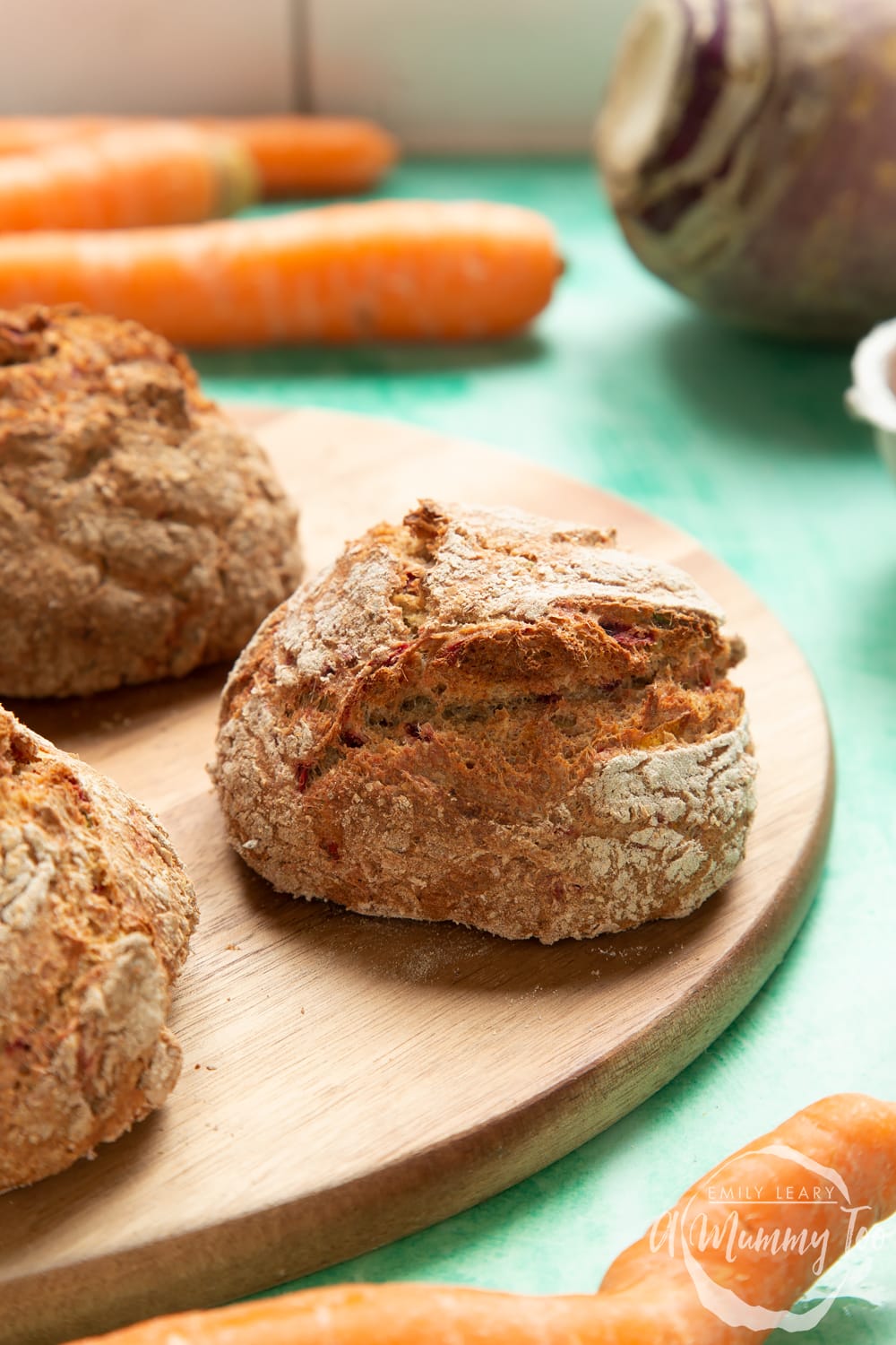 Vegetable soda bread rolls recipe - rolls arranged on a board, one roll in focus showing crust.